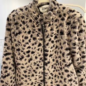 Snow leopard faux fur jacket with black  trim.